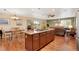 Open kitchen with granite countertops, center island with cooktop, and hardwood floors at 12337 2Nd St, Parker, CO 80134