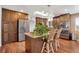 A modern kitchen with stainless steel appliances, a center island, and hardwood floors at 12337 2Nd St, Parker, CO 80134
