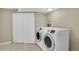 Bright laundry room featuring modern appliances and ample closet space at 12337 2Nd St, Parker, CO 80134
