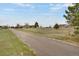 A level lot with a long driveway and some scattered trees in a rural residential neighborhood at 12337 2Nd St, Parker, CO 80134