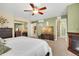 Spacious main bedroom featuring a ceiling fan, and a decorative fireplace at 12337 2Nd St, Parker, CO 80134