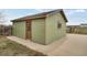 Exterior view of small outbuilding with wooden door and siding at 12337 2Nd St, Parker, CO 80134