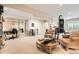 Open basement area featuring neutral carpeting, a home gym, an office area, and comfortable seating at 2838 Cascade Creek Dr, Lafayette, CO 80026