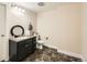 Well-lit bathroom with dark vanity, modern fixtures, and sleek tiled flooring at 2838 Cascade Creek Dr, Lafayette, CO 80026