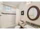 Cozy bathroom featuring a shower-tub combo, granite countertop and sink, and window for natural light at 2838 Cascade Creek Dr, Lafayette, CO 80026