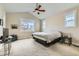 Bedroom with vaulted ceilings, a ceiling fan, and two large windows overlooking the neighborhood at 2838 Cascade Creek Dr, Lafayette, CO 80026