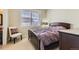 Bedroom with a large window, wood-framed bed, a chair, and carpet flooring at 2838 Cascade Creek Dr, Lafayette, CO 80026