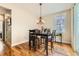 Well-lit dining area features wood flooring, a modern chandelier, and a large window at 2838 Cascade Creek Dr, Lafayette, CO 80026