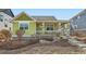 Inviting home showcasing a covered front porch, green and white color palette, plus a well-maintained landscape at 2838 Cascade Creek Dr, Lafayette, CO 80026