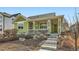 Charming single-Gathering home featuring a welcoming front porch, green siding and landscaped front yard at 2838 Cascade Creek Dr, Lafayette, CO 80026