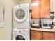 Efficient laundry area featuring stacked washer and dryer, plus cabinets for storage at 2838 Cascade Creek Dr, Lafayette, CO 80026