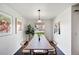 Stylish dining room featuring neutral-toned decor, modern light fixture, and outside view at 7346 S Xenia Cir # A, Centennial, CO 80112