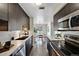 Modern kitchen featuring stainless steel appliances, white countertops, and wood flooring at 7346 S Xenia Cir # A, Centennial, CO 80112