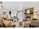 Bright living room featuring stone fireplace, stylish furniture, and a walkout patio at 7346 S Xenia Cir # A, Centennial, CO 80112