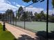 Enjoy a match on this outdoor tennis court, surrounded by a chain-link fence and mature trees at 7346 S Xenia Cir # A, Centennial, CO 80112
