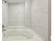 Bright bathtub and shower alcove featuring modern white marble-style tile surround at 5243 Union Ct # 4, Arvada, CO 80002