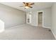 Spacious bedroom featuring neutral carpet, a ceiling fan, and access to an ensuite bathroom at 5243 Union Ct # 4, Arvada, CO 80002