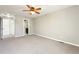 Large bedroom with soft carpeting, a ceiling fan, and convenient access to both closets and bathroom at 5243 Union Ct # 4, Arvada, CO 80002