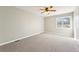 Spacious bedroom with neutral tones, carpet flooring, a ceiling fan, and a window at 5243 Union Ct # 4, Arvada, CO 80002