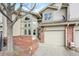 Beautiful townhome showcasing brick accents, an attached garage, and manicured landscaping at 5243 Union Ct # 4, Arvada, CO 80002