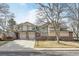 Inviting townhome with a well-maintained lawn, attached garage, and brick accents at 5243 Union Ct # 4, Arvada, CO 80002