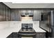 Modern kitchen featuring stainless steel appliances, sleek dark cabinetry, and ample counter space at 5243 Union Ct # 4, Arvada, CO 80002