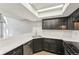 Bright kitchen featuring dark cabinets, stainless steel appliances, and a skylight for natural light at 5243 Union Ct # 4, Arvada, CO 80002