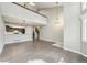Spacious living room with hardwood floors, modern lighting, and an open concept kitchen at 5243 Union Ct # 4, Arvada, CO 80002