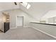 Open living room with loft features high ceilings, skylight, plush carpeting, and ample closet space at 5243 Union Ct # 4, Arvada, CO 80002
