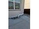 Exterior view showing foundation, patio and basement egress window at 968 Honey Berry Ct, Elizabeth, CO 80107