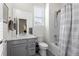 Well-lit bathroom with a shower-tub combo, gray vanity and a marble countertop at 968 Honey Berry Ct, Elizabeth, CO 80107