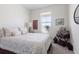 Bright bedroom featuring white walls, neutral bedding, and charming travel-themed decor at 968 Honey Berry Ct, Elizabeth, CO 80107