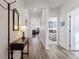 Inviting hallway with wood floors, a vintage table, and views into the home's interior at 968 Honey Berry Ct, Elizabeth, CO 80107