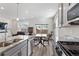 Modern kitchen with granite counters flows into dining area, creating an open and inviting living space at 968 Honey Berry Ct, Elizabeth, CO 80107
