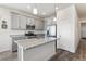 Well-lit kitchen features stainless steel appliances, granite countertops, and a central island with a sink at 968 Honey Berry Ct, Elizabeth, CO 80107