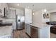 Modern kitchen with stainless steel appliances, a spacious island, and gray cabinets at 968 Honey Berry Ct, Elizabeth, CO 80107