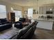 Open-concept living space with wood flooring, a comfortable seating area, and a modern kitchen at 968 Honey Berry Ct, Elizabeth, CO 80107