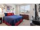 Bright main bedroom featuring a large window and a dresser at 968 Honey Berry Ct, Elizabeth, CO 80107