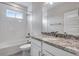 Bathroom featuring granite countertop, subway tile and shower-tub combination at 8581 Eckley St, Littleton, CO 80125
