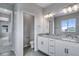 Bathroom featuring double vanity, granite countertop, and tiled floors at 8581 Eckley St, Littleton, CO 80125