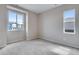 Neutral bedroom with plush carpet and bright windows with neighborhood views at 8581 Eckley St, Littleton, CO 80125