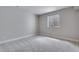 Cozy bedroom with neutral carpet, a bright window, and fresh paint ready for personal touches at 8581 Eckley St, Littleton, CO 80125