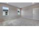 Spacious bedroom featuring plush carpet, two windows, and a closet at 8581 Eckley St, Littleton, CO 80125