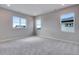 Bright bedroom with plush carpet and three windows offering plenty of natural light at 8581 Eckley St, Littleton, CO 80125