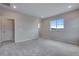 Bedroom with plush carpet features a bright window and ample outlets at 8581 Eckley St, Littleton, CO 80125