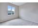 Neutral bedroom with plush carpet and a large window at 8581 Eckley St, Littleton, CO 80125
