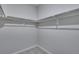 Bright walk-in closet featuring carpet floors and metal storage racks at 8581 Eckley St, Littleton, CO 80125