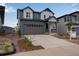 Two-story home with a gray garage and ample driveway space at 8581 Eckley St, Littleton, CO 80125