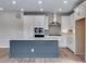 Bright kitchen with white cabinetry, modern appliances, and a central island with light countertops at 8581 Eckley St, Littleton, CO 80125