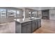 Spacious kitchen with a large island, stainless steel appliances, and modern finishes at 8581 Eckley St, Littleton, CO 80125